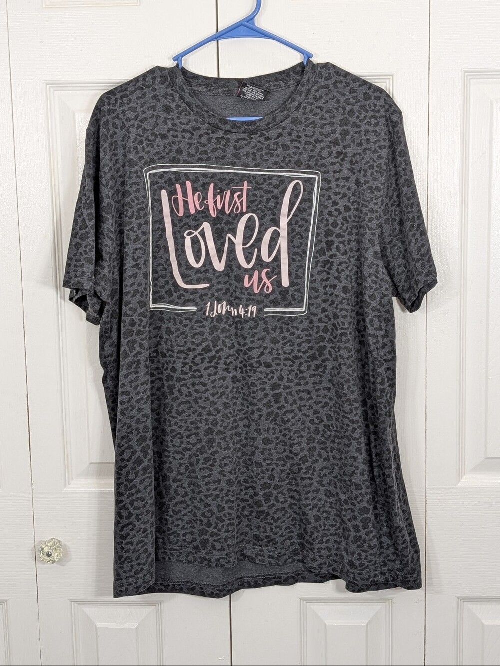 Love in Faith: "He First Loved Us" Gray Leopard Tee - Size XL